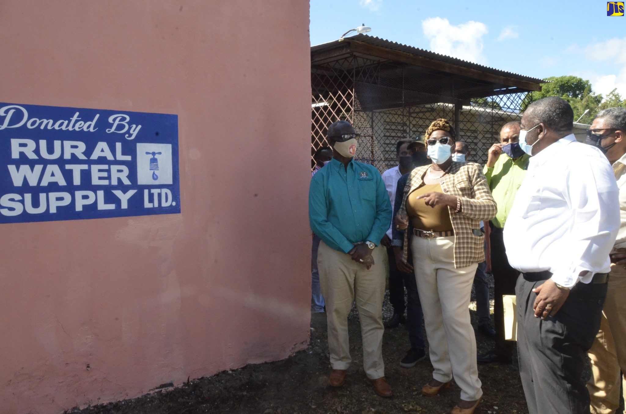 – Minister of Local Government and Rural Development, Hon. Desmond McKenzie (left), is shown a concrete water-harvesting tank at the Springfield Primary and Infant School in St. Elizabeth, by Principal, Winsome Coke (second left), during a recent tour of the school by the Minister. Also participating in the tour are (from third left) Mayor of Black River, Councillor Derrick Sangster; Managing Director of Rural Water Supply Limited (RWSL), Audley Thompson and Deputy Chairman of RWSL , Peter Clarke. 
