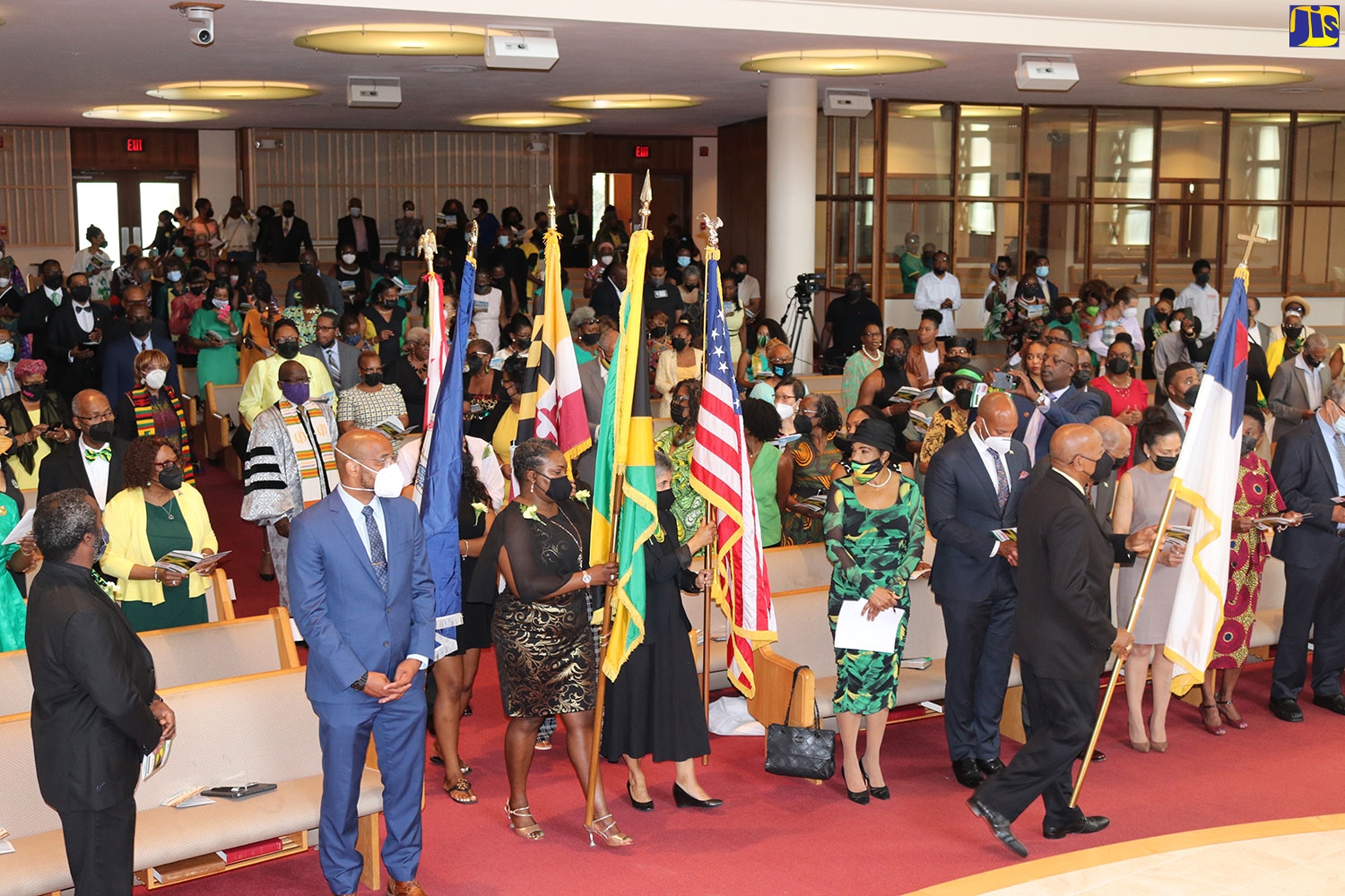 Flag bearers enter the sanctuary in Takoma Park, Maryland, signalling the commencement of the Thanksgiving Service to mark Jamaica’s Diamond Jubilee and 184 years of Emancipation. Leading the procession is Rick Nugent, president of the Jamaican Association of Maryland. Bearing the Jamaica flag is Kerry Anderson-Dixon; Ingrid Jallier carries the USA flag – both are Embassy staff members. They are accompanied by others bearing the flags of the District of Columbia (Washington DC), the state of Maryland, and the Commonwealth of Virginia. Looking on (from centre) is Jamaica’s Ambassador to Washington. Audrey Marks. 