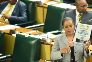Minister of Legal and Constitutional Affairs, Hon. Marlene Malahoo Forte, displays a copy of the report of the Constitutional Reform Committee (CRC) during her contribution to the 2024/25 Sectoral Debate in the House of Representatives on Tuesday (June 11).

