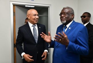 Governor General, His Excellency the Most Hon. Sir Patrick Allen (left), in discussion with Chairman, National Identification Registration Authority (NIRA), Bishop the Hon. Conrad Pitkin. The occasion was Friday’s (November 15) official launch of the NIRA, located at the Central Sorting Office (CSO) in Kingston, where the Governor General enrolled and received his national identification card. 