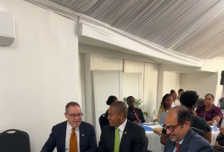 Minister of Agriculture, Fisheries and Mining, Hon. Floyd Green (centre), speaks with High Commissioner of Canada to Jamaica, His Excellency Mark Berman (left), during the recent launch of the Gender-responsive Climate-smart Agriculture and Food Systems in the Caribbean project, at the Spanish Court Hotel in Kingston. At right is Counsellor (Development) and Head of Cooperation, High Commission of Canada to Jamaica, Shehryar Sarwar.

