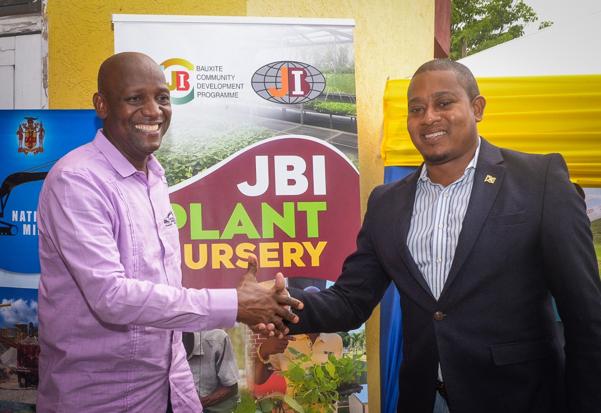 Minister of Agriculture, Fisheries and Mining, Hon. Floyd Green (right), exchanges greetings with Principal Director Mining/Minerals Policy and Development in the Ministry, Dr. Oral Rainford, at the Bauxite/Alumina Industry Day event under the theme: ‘The Future of Bauxite,’ at the Jamaica Bauxite Institute (JBI) at Hope Gardens in St. Andrew on Friday (May 30).