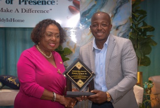Minister of Culture, Gender, Entertainment and Sport, Hon. Olivia Grange, presents a commemorative plaque to Minister of Labour and Social Security, Hon. Pearnel Charles Jr., in recognition of his outstanding role as a father, during the Ministry’s Outstanding Father Awards Ceremony on Friday (June 13) at the Jamaica Pegasus Hotel in New Kingston. The event was held under the theme: ‘The Power of Presence: Fathers Who Make a Difference’.

