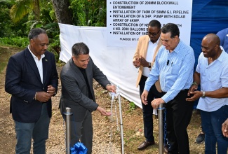 Minister without Portfolio in the Ministry of Economic Growth and Job Creation, Hon. Matthew Samuda (second left), commissions the new $23-million water supply system in the Lapland District of Catadupa, St. James, on Wednesday, June 4. He is joined by (from left) Chairman of the Rural Water Supply Limited, Omar Sweeney; Councillor for the Cambridge Division, Javin Baker; Minister of State in the Office of the Prime Minister (West), Hon. Homer Davis; and Chairman of the function, Everes Coke.

