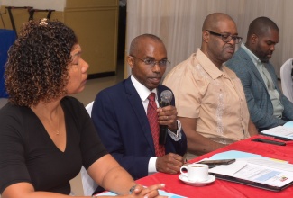 Permanent Secretary in the Office of the Prime Minister, Ambassador Dr. Rocky Meade (second left), gives opening remarks at the Postal Corporation of Jamaica Limited’s Board Retreat at the Terra Nova All-Suite Hotel in Kingston, on Wednesday (June 4). He is flanked by Chairman of the Board of Directors, Professor Lloyd Waller (second right); Board Member, Marjorie Shaw and Deputy Chairman, Damion Brown.