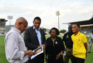 Prime Minister, Dr. the Most Hon. Andrew Holness (second left), and Minister of Culture, Gender, Entertainment and Sport, Hon. Olivia Grange, review plans for the Sabina Park lighting project with Citrad Limited Managing Director, Alwyn Akin (left), on Monday (June 16) following the official switch-on. The Government invested $75 million in the project, enabling the venue to host day/night Test and T20 cricket matches. Also present were Permanent Secretary in the Sport Ministry, Denzil Thorpe (second right), and Jamaica Cricket Association (JCA) President, Dr. Donovan Bennett.

