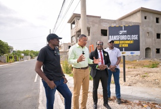 Prime Minister, Dr. the Most Hon. Andrew Holness (second left), in discussion with (from left) Minister without Portfolio in the Ministry of Economic Growth and Job Creation with Responsibility for Works, Hon. Robert Morgan; State Minister in the Ministry of Foreign Affairs and Foreign Trade and Member of Parliament for St. Catherine East Central, Hon. Alando Terrelonge; and National Works Agency (NWA) Senior Director, Project Implementation, Varden Downer, during a tour of Ransford Close in Cedar Grove, Portmore, St. Catherine, on Wednesday (June 25). Ransford Close is among the four roads completed under the Shared Prosperity Through Accelerated Improvement to Our Road Network (SPARK) Programme in Portmore, for which signs were unveiled. The others are Suzan Avenue in Edgewater, Mahoe Drive in Bridgeport, and Jasmin Close in Hamilton Gardens.

