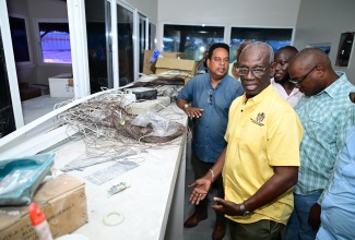 Minister of Local Government and Community Development, Hon. Desmond McKenzie (left, foreground), and other stakeholders observe renovation works underway at the Yallahs Market in St. Thomas during a site visit on Friday (July 25).