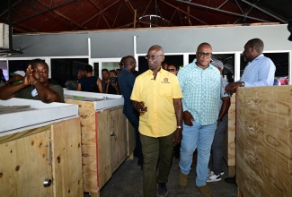 Minister of Local Government and Community Development, Hon. Desmond McKenzie (left), Councillor for the Yallahs Division, John Lee (centre), and other stakeholders tour the Yallahs Market in St. Thomas on July 25 to assess the progress of renovation works that commenced last year.


