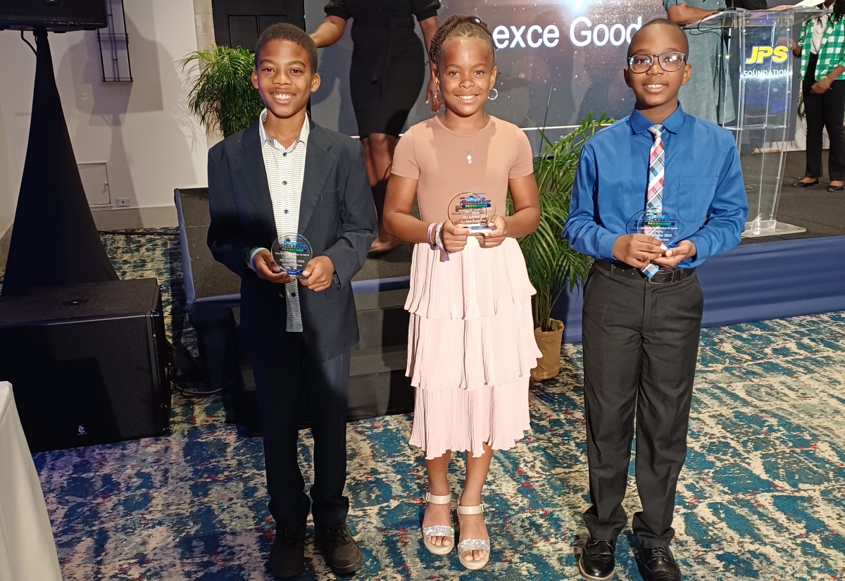 Jamaica Public Service (JPS) Volunteers on Location to Serve (VOLTS) PEP Scholarship recipients (from left) Samuel Ridgard; Adrianna Willie, and Blake Wilson display their trophies during the JPS PowerUp Scholarship awards ceremony, held on Thursday (July 24), at The Jamaica Pegasus hotel in New Kingston. 