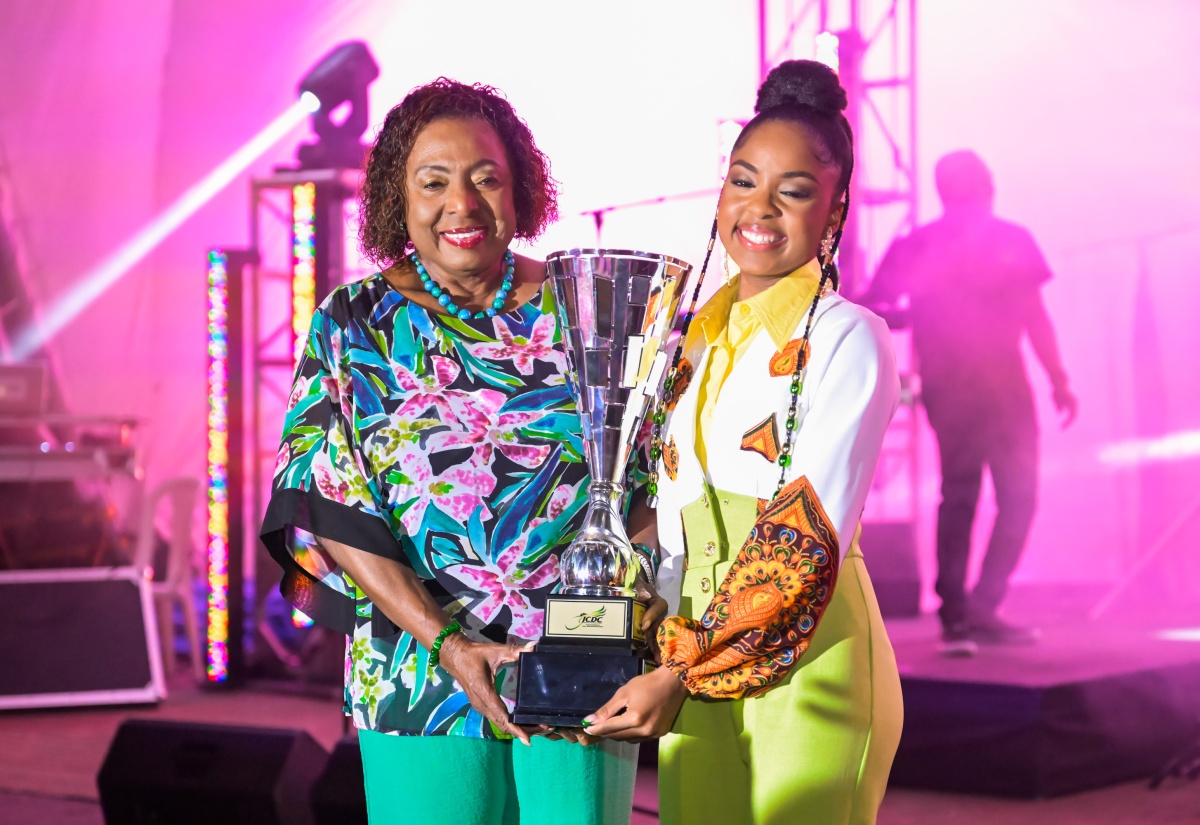 Minister of Culture, Gender, Entertainment and Sport, Hon. Olivia Grange (left), presents the Jamaica Festival Song Trophy to 2025 winner, Abigail ‘Abi-D’ Dunstan, who walked away with the coveted award for her entry - ‘Sweet JA’. The final of the Jamaica Cultural Development Commission (JCDC)-organised competition took place on Saturday (July 26) at Emancipation Park in St. Andrew.