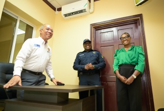 Deputy Prime Minister and Minister of National Security, Hon. Dr. Horace Chang (left), Minister of State in the Ministry of National Security and Member of Parliament for West Rural St. Andrew, Juliet Cuthbert-Flynn, and Acting Superintendent of Police, Jamaica Constabulary Force (JCF), Joel Hamilton, share a moment while touring the newly opened Stony Hill Police Station in St. Andrew on Wednesday (July 30).