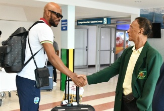 President of the Jamaica Cricket Association, Dr. Donovan Bennett (right), greets West Indies cricketer Roston Chase, during the arrival of the West Indies Cricket team and the touring Australian side at the Norman Manley International Airport (NMIA) in Kingston on Tuesday (July 8). They are in the island for the third Test, set for July 12–16 at Sabina Park, followed by two T20 matches on July 20 and 22.

