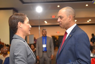 Minister of Foreign Affairs and Foreign Trade Minister, Senator the Honourable Kamina Johnson Smith (left), is pictured speaking with Government Senator and GraceKennedy Limited Chief Executive Officer, Don Wehby, during the 2019 launch of the Eighth Biennial Jamaica Diaspora Conference at the Jamaica Pegasus Hotel in New Kingston.


