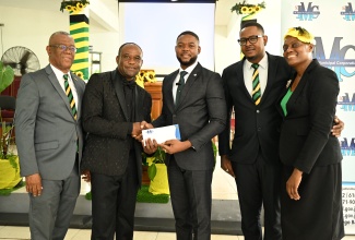 Chairman of the St. James Municipal Corporation and Mayor of Montego Bay, Councillor Richard Vernon (centre), hands over a gift to Minister Sheldon Cohen (second left) during the Emancipation/Independence Church Service, held at the Blessed Hope Assembly Christ Gospel Church of Jamaica Apostolic in Copperwood, St. James, on Sunday, July 27. They are joined by (from left) Government Senator, Charles Sinclair; Councillor Javin Baker; and wife of the pastor of the church, Cheryl Mitchell.

