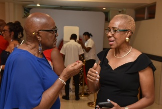 Minister of Finance and Public Service, Hon. Fayval Williams (right), is in conversation with businesswoman Audrey Stewart-Hinchcliffe at e-Learning Jamaica’s 20th Anniversary Gala and Awards held recently at The Jamaica Pegasus hotel in New Kingston.