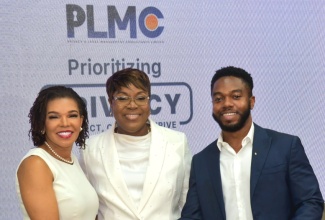 Minister without Portfolio in the Office of the Prime Minister with responsibility for Efficiency, Innovation, and Digital Transformation, Senator the Hon. Ambassador Audrey Marks (left), is greeted by Privacy and Legal Management Consultants (PLMC) Lead Compliance and Software Engineer, William Henlin (right), during PLMC’s Prioritising Privacy: Protect, Comply, Thrive conference, held at the University of the West Indies (UWI) Regional Headquarters in St. Andrew, on Tuesday (July 1). Sharing the moment is PLMC Managing Director, M. Georgia Gibson Henlin.