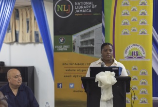 Jamaica Libraries and Information Network (JAMLIN) Development Manager, Jasheka Robinson, delivers remarks during a Disaster Management Workshop, which was held at the Kingston and St. Andrew Parish Library on Monday (June 30). At left is workshop facilitator, Dr. Roberto Rivera. The workshop was held to highlight the critical role of libraries as safe spaces for families and communities during natural disasters.

