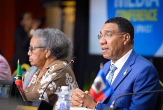 Caribbean Community (CARICOM) Chairman, and Prime Minister, Dr. the Most Hon. Andrew Holness (right), answers questions during the Closing Press Conference for the 49th Regular Meeting of the CARICOM Heads of Government at the Montego Bay Convention Centre in Rose Hall, St. James, on Tuesday (July 8). At left is CARICOM Secretary-General, Dr. Carla Barnett.

