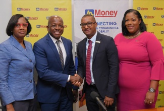 Minister of Labour and Social Security, Hon. Pearnel Charles Jr. (second left), shares a symbolic handshake with General Manager of JN Money Services, Horace Hines (third left), during Wednesday’s (July 9) launch of the Jamaica National (JN) Fields of Opportunity Scholarships, held at the JN Financial Centre on Belmont Road in Kingston. Sharing the moment (from left) are Acting Permanent Secretary in the Ministry, Dionne Jennings; and Assistant General Manager of JN Money Services, Sanya Wallace. 