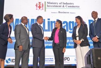 Prime Minister, Dr. the Most Hon. Andrew Holness (third left), congratulates Founder and Chief Executive Officer, STEM Builders Learning Hub, and winner of the MSME Masters Business Pitch Competition, Kavelle Hylton, during the Ministry of Industry, Investment and Commerce MSME Linkages day event at the University of Technology (UTech) in St. Andrew. Sharing the moment (from left) are Permanent Secretary in the Ministry, Sancia Bennett Templer; Portfolio Minister, Senator the Hon. Aubyn Hill; Inter-American Development Bank (IDB) Chief of Operations, Jamaica, Karisa Ribeiro; and Managing Director, Development Bank of Jamaica (DBJ), Dr. David Lowe.