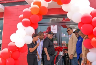 Prime Minister, Dr. the Most Hon. Andrew Holness (third right), officially opens the KFC Black River branch in St. Elizabeth on Saturday (July 26). He is joined by (from left) Restaurants of Jamaica (ROJ) Director of Marketing, Tina Myers Matalon; Minister of Agriculture, Fisheries and Mining, Hon. Floyd Green; ROJ Managing Director, Mark Myers; Minister of Industry, Investment and Commerce, Senator the Hon. Aubyn Hill; and President of the St. Elizabeth Chamber of Commerce (Black River Chapter), Kadian Myers-Brown. 