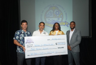 Mayor of Montego Bay, Councillor Richard Vernon (right), shares in the handover of a cheque valued at $800,000 by Vice President of the Montego Bay Chamber of Commerce and Industry (MBCCI), Richard Burrowes (left) and MCCI President, Jason Russell, to Marketing Director and Programme Manager at Women of Destiny (WOD) charitable organisation, Kriss-Ann Haughton. The presentation was made on Wednesday (July 22) at the Jewel Grande Hotel in Montego Bay, St. James.

