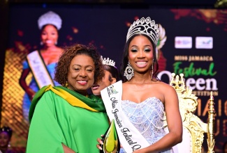 Minister of Culture, Gender, Entertainment and Sport, Hon. Olivia Grange (left), presents Jamaica Festival Queen 2025, Brithney Clarke (right), with her trophy during the Festival Queen Coronation Show, held on Saturday night (Aug. 2) at the National Indoor Sports Centre in Kingston. Miss Clarke, representing Kingston & St. Andrew, also won several sectional prizes, including Most Congenial, Most Poised, and Most Popular on Social Media.