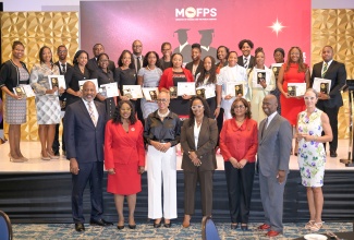 Minister of Finance and the Public Service, Hon. Fayval Williams (front, third left) poses with the selection committee and the 2025 recipients of the Marcus Garvey Public Sector Graduate Scholarship during the programme’s awards ceremony and engagement session held at The Jamaica Pegasus hotel in New Kingston on Wednesday (August 13). Twenty-eight public-sector workers were awarded full scholarships during the ceremony.