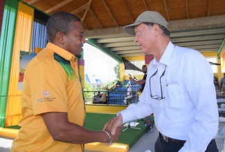 Minister of Agriculture, Fisheries and Mining, Hon. Floyd Green (left), greets Japanese Ambassador to Jamaica, His Excellency Yasuhiro Atsumi, on Day Two of the 71st staging of the Denbigh Agricultural, Industrial and Food Show, at the Denbigh Showground in May Pen, Clarendon, on Saturday (August 2).