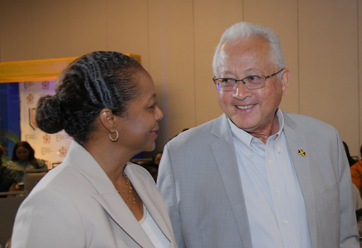 Minister of Legal and Constitutional Affairs, Hon. Marlene Malahoo Forte (left), in conversation with Minister of Justice, Hon. Delroy Chuck, during the launch of the Jamaica Legal Information Portal (JLIP), at AC Hotel by Marriott in Kingston, on July 30.


