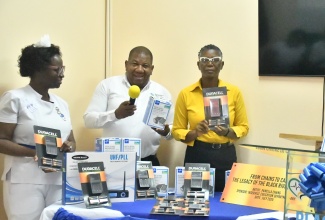 Regional Director of the Southern Regional Health Authority (SRHA), Michael Bent (centre) tests a microphone donated by the In-Service Department of the Black River Hospital in St. Elizabeth on August 5. The microphone was among several items donated to the hospital by the Department, including blood pressure testing machines, a public-address system, two lecterns and a mural. Displaying some of the items (from left) are Nurse Manager with responsibility for the In-service Education Department, Dorcia Brown-Lyle, and Chief Executive Officer at the hospital, Diana Brown-Miller.

